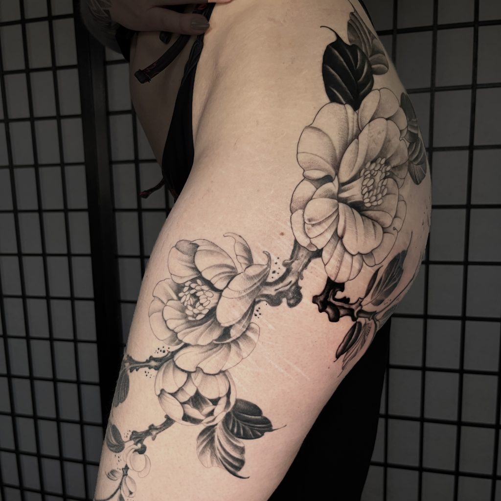 Black and grey floral tattoo on leg done by Anna at Tiger & Rose Tattoo, London