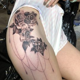Realistic tattoo of roses on hip