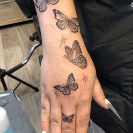 butterflies on hand tattoo