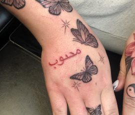 Script tattoo on hand
