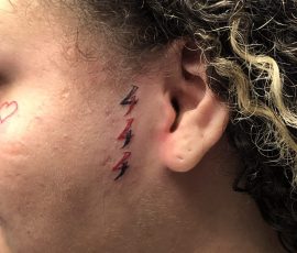 444 tattoo in front of ear