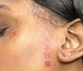 red Chinese script on face