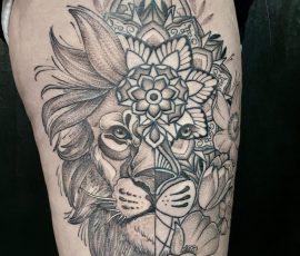 Lion with geometric design tattoo