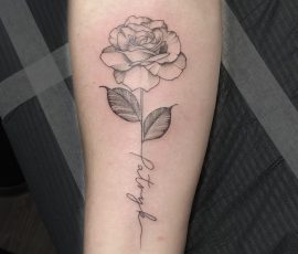 Rose tattoo with script in stem