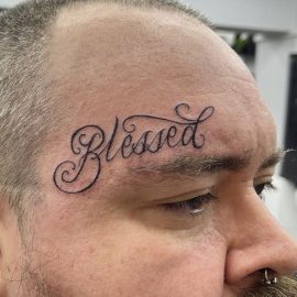 Scipt tattoo over eyebrow