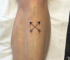 Crossed arrows tattoo