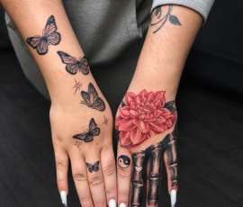 Skeleton finger hand tattoo with flower and butterflies hand tattoo