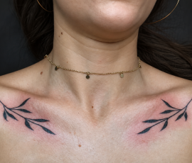 Olivr branches tattoo under collarbone