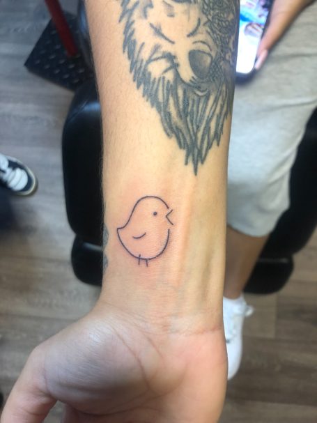 Outlined chick tattoo